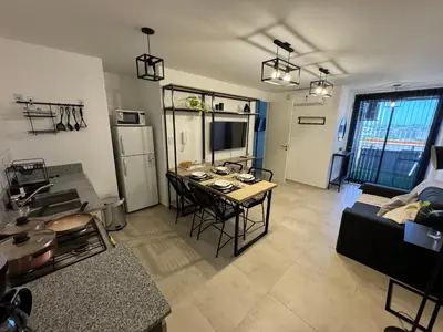 a living room with a table and a couch at A 3 cuadras de Patio Olmos in Cordoba