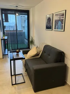 a living room with a couch and a table at A 3 cuadras de Patio Olmos in Cordoba