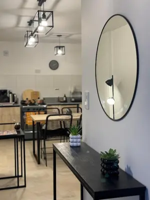 a room with a table and a mirror on the wall at A 3 cuadras de Patio Olmos in Cordoba