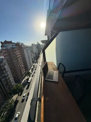 a laptop sitting on top of a table on a balcony at A 3 cuadras de Patio Olmos in Cordoba