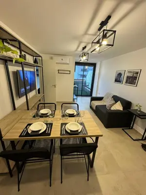 a living room with a wooden table and chairs at A 3 cuadras de Patio Olmos in Cordoba
