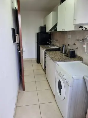 a kitchen with a washer and dryer in it at Hermoso y cómodo Dpto en el centro in Cordoba
