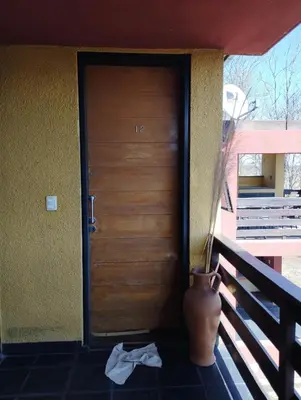 a vase sitting in front of a door at Paraíso Serrano 12 in Villa Ciudad Parque