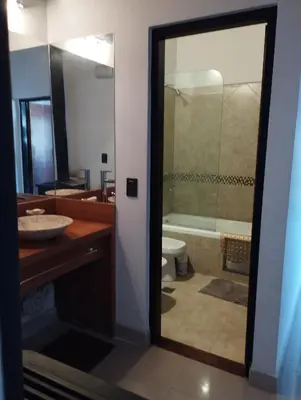 a bathroom with a sink and a toilet and a shower at Paraíso Serrano 12 in Villa Ciudad Parque