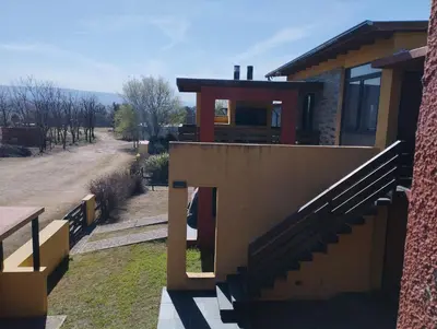 a house with a staircase on the side of it at Paraíso Serrano 12 in Villa Ciudad Parque
