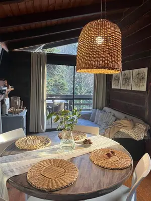 a dining room with a table with baskets on it at Willert Cabañas Cumbrecita in La Cumbrecita