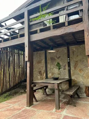 a potted plant sitting on a picnic table under a pergola at Willert Cabañas Cumbrecita in La Cumbrecita