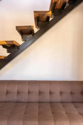 a couch in a waiting room with wooden beams at Cabañas Miraluna in Villa General Belgrano