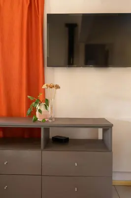 a cabinet with a tv on top of it at Cabañas Miraluna in Villa General Belgrano