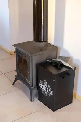a stove sitting on top of a box on the floor at Cabañas Miraluna in Villa General Belgrano