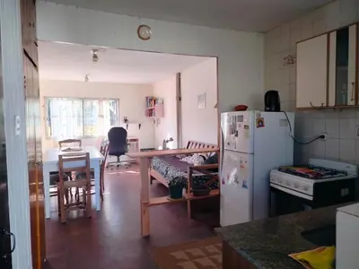 a kitchen with a refrigerator and a table in it at Guemes270 in San Roque