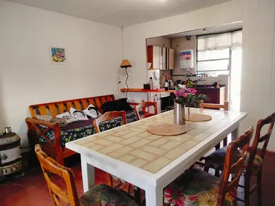 a kitchen with a white table with chairs and a dining room at Guemes270 in San Roque