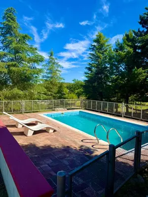 a swimming pool with a fence around it at Alma de Lago in Villa Rumipal