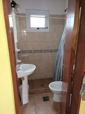 a bathroom with a sink and a toilet at Alma de Lago in Villa Rumipal