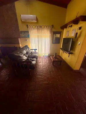 a living room with a couch and a television at Alma de Lago in Villa Rumipal