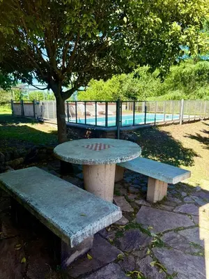 a picnic table and bench next to a tree at Alma de Lago in Villa Rumipal