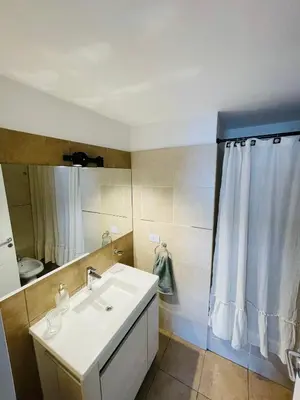 a bathroom with a sink and a shower curtain at CATEGORIA departamento a dos cuadras del patio olmos 1 dormitorio asador pileta y cochera in Cordoba