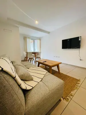 a living room with a couch and a table at CATEGORIA departamento a dos cuadras del patio olmos 1 dormitorio asador pileta y cochera in Cordoba