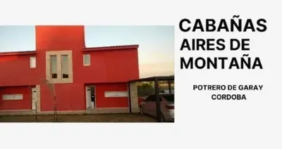 a red building with the words cazams atlas de montana at Cabañas Aires de Montaña in La Estancia