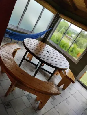 a wooden bench sitting in front of a window at Cabañas Aires de Montaña in La Estancia