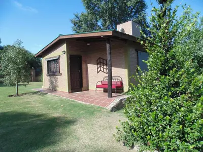 a gazebo with a red bench on a patio at Cabañas los amigos Pino in Potrero de Garay