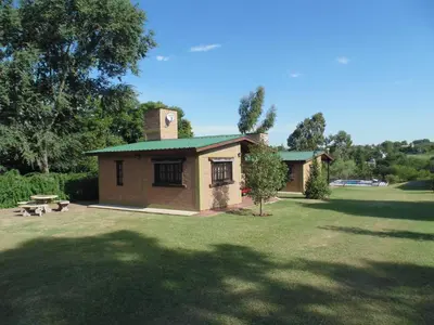 a small house with a chimney on top of a yard at Cabañas los amigos Pino in Potrero de Garay