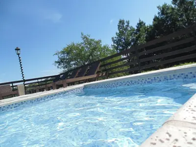 a swimming pool with a fence around it at Cabañas los amigos Pino in Potrero de Garay