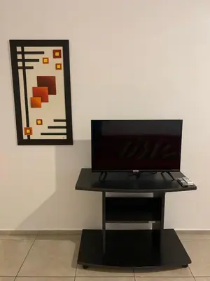 a black table in front of a wall with a picture at Hermoso departamento amoblado ubicado en pleno Nueva Córdoba in Cordoba