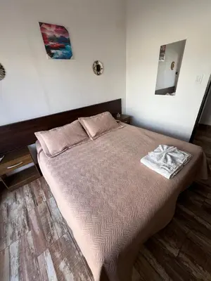 a bedroom with a bed with a towel on it at Complejo Roccatini in Villa Carlos Paz