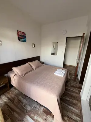 a bedroom with a large bed in a room at Complejo Roccatini in Villa Carlos Paz