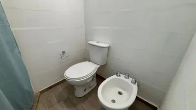 a small bathroom with a toilet and a bidet at Amanecer Serrano Carlos Paz in Villa Carlos Paz