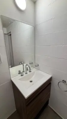 a bathroom with a sink and a mirror at Amanecer Serrano Carlos Paz in Villa Carlos Paz