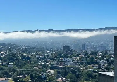 a view of a city with clouds in the sky at Amanecer Serrano Carlos Paz in Villa Carlos Paz