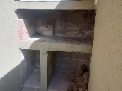 an inside view of a brick oven in a building at Magnolias in Villa General Belgrano