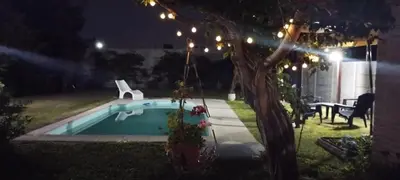 a backyard with a swimming pool at night at Alma Dulce in Almafuerte