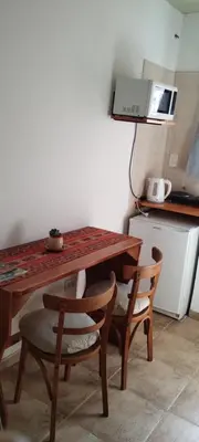 a kitchen with a wooden table and two chairs at Alma Dulce in Almafuerte
