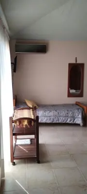 a bedroom with a bed and a tv on the wall at Alma Dulce in Almafuerte