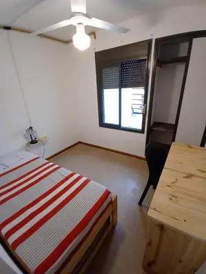 a room with a bed and a desk and a window at Residencia Art in Cordoba