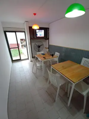 a dining room with tables and chairs and a television at Residencia Art in Cordoba