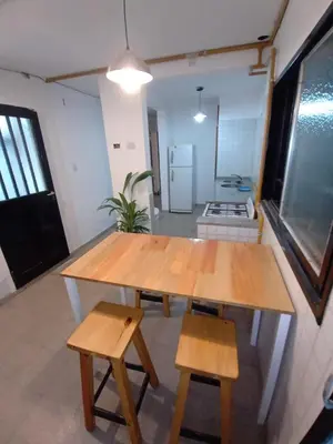 a wooden table and two chairs in a room at Residencia Art in Cordoba