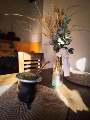 a table with a vase and a vase of flowers on it at Cabañas De La Vertiente in La Bolsa