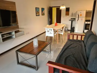 a living room with a couch and a table at Venetto Village in Villa Parque Siquiman