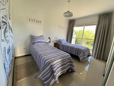two beds with striped blankets in a room at Venetto Village in Villa Parque Siquiman