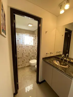 a bathroom with a toilet and a sink and a mirror at Venetto Village in Villa Parque Siquiman