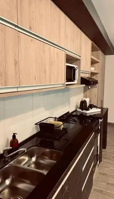 a kitchen with a sink and a microwave at Depto Villa Carlos Paz in Villa Carlos Paz