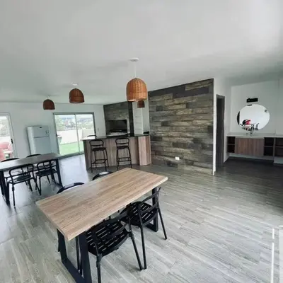 a kitchen and dining room with a wooden table and chairs at Depto Villa Carlos Paz in Villa Carlos Paz