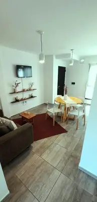 a living room with a table and a couch at Departamento Rivera in Cordoba