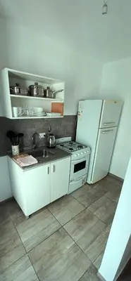 a kitchen with a stove and a refrigerator at Departamento Rivera in Cordoba