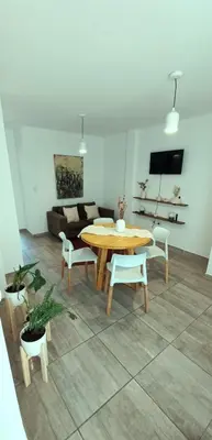 a living room with a table and chairs and a couch at Departamento Rivera in Cordoba
