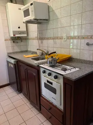 a kitchen with a stove and a counter top at Complejo Villa General Belgrano in Villa General Belgrano